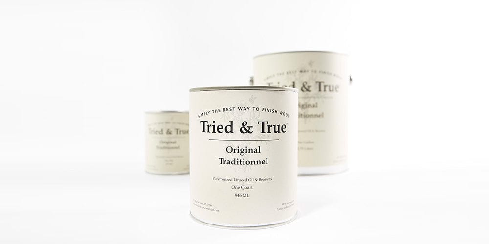 Three cans of TRD Tried & True Original Wood Finish, renowned for its linseed oil and beeswax blend, are showcased against a light background. The cans come in different sizes, with one larger can positioned in the foreground and two smaller ones in the background, ideal for protecting interior wood surfaces.