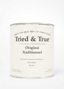A can of TRD "Tried & True Original Wood Finish," a blend of linseed oil and beeswax, featuring a cream-colored label with black text on a white background, ensures interior wood protection.