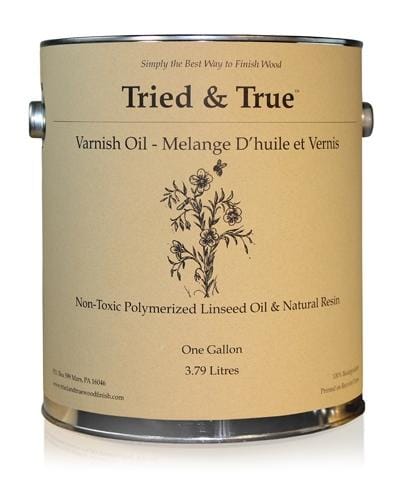 A one-gallon can of TRD's Tried & True Varnish Oil Finish, featuring non-toxic polymerized linseed oil and natural resin for a premium wood finish. The label includes English and French descriptions with a decorative floral illustration, perfect for enhancing interior woodwork.