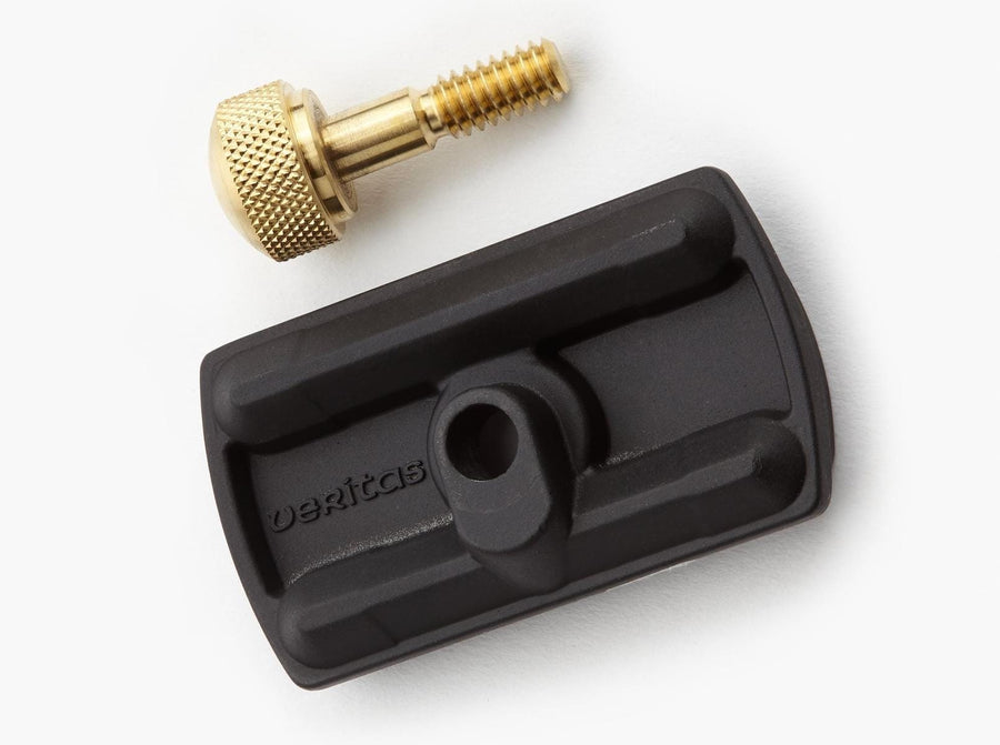 The VER Mortise Chisel Adapter for Veritas Mk.II Narrow-Blade Honing Guide, shown in black with a central hole and grooves, is paired with a gold knurled screw—perfect for honing guide or mortise chisel use.