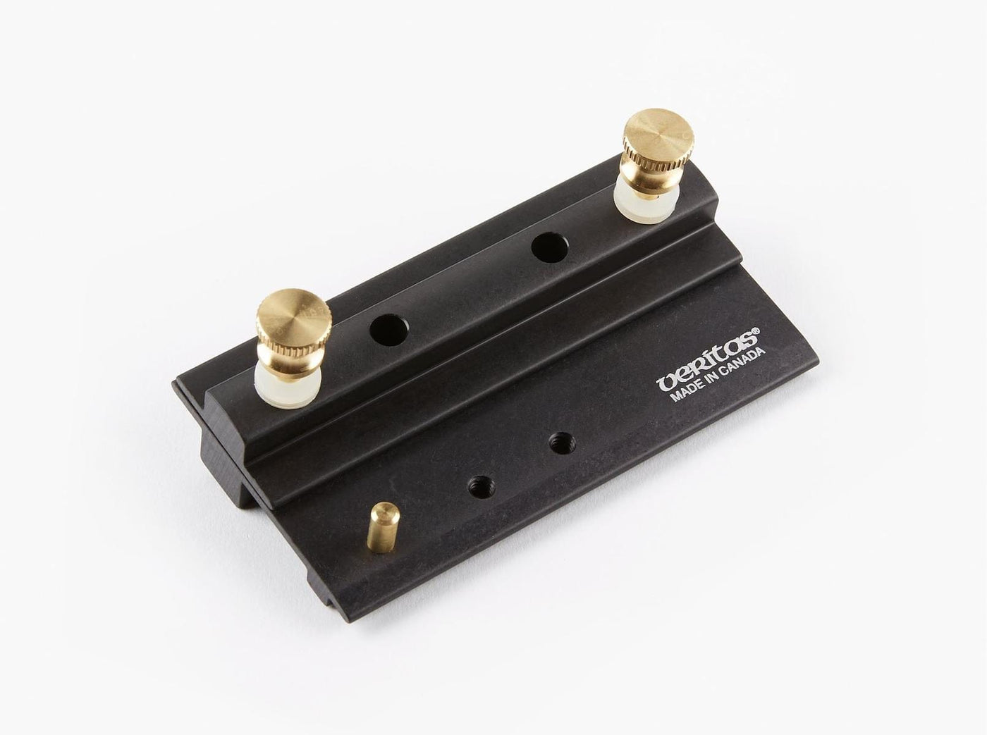 The VER Veritas Grinding Jig is a black metal tool with two brass knobs, white plastic washers, and the Veritas logo. Made in Canada, it features multiple holes and a brass pin for precise bevel angle adjustment.