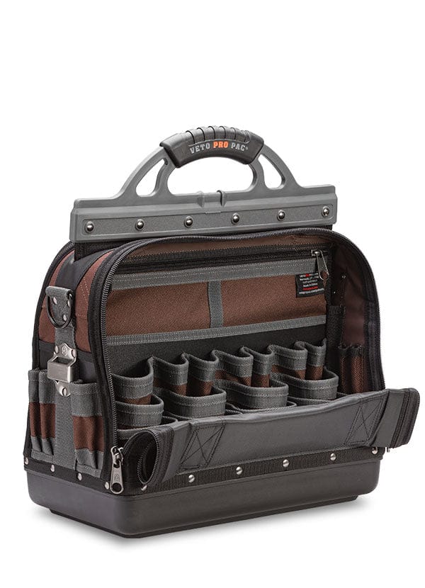 The VET Extra Large Compact Tool Bag features a rugged gray and brown design, durable materials, hard plastic handle, multiple pockets inside and out, and a zippered flap for optimal tool storage and organization.