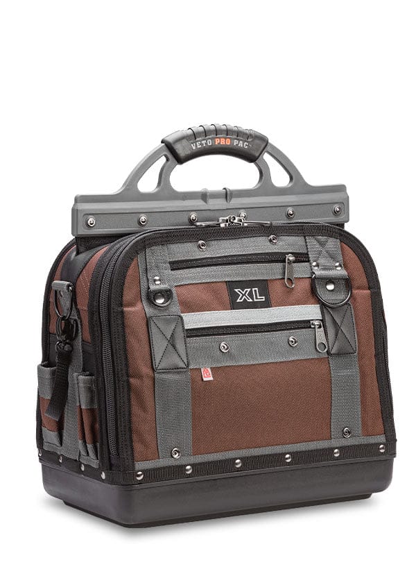 The VET Extra Large Compact Tool Bag features a sturdy handle, rugged base, reinforced corners, and multiple pockets in brown and gray, designed for maximized tool storage.