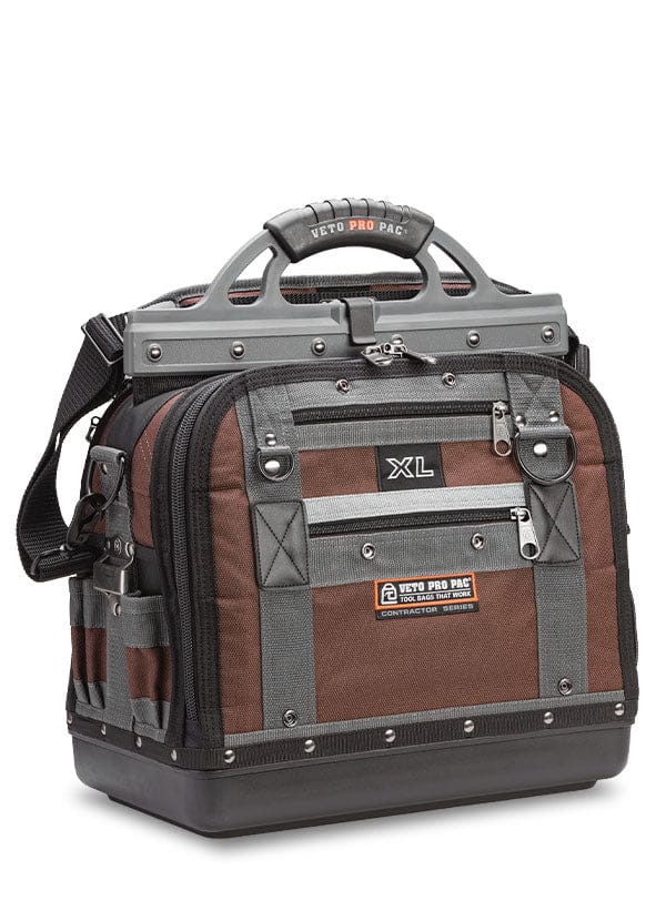 The VET Extra Large Compact Tool Bag in brown and black boasts rugged materials, a sturdy handle, shoulder strap, multiple pockets, and reinforced edges for optimal tool storage and organization.
