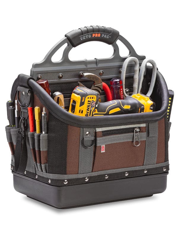The Veto Pro Pac Large Open Top Tool Bag by VET is a compact tool bag packed with various tools, including a yellow cordless drill, screwdrivers, pliers, and a tape measure. The tote is black, brown, and gray with multiple compartments and pockets, showcasing its impressive tool storage capacity crafted from rugged materials.