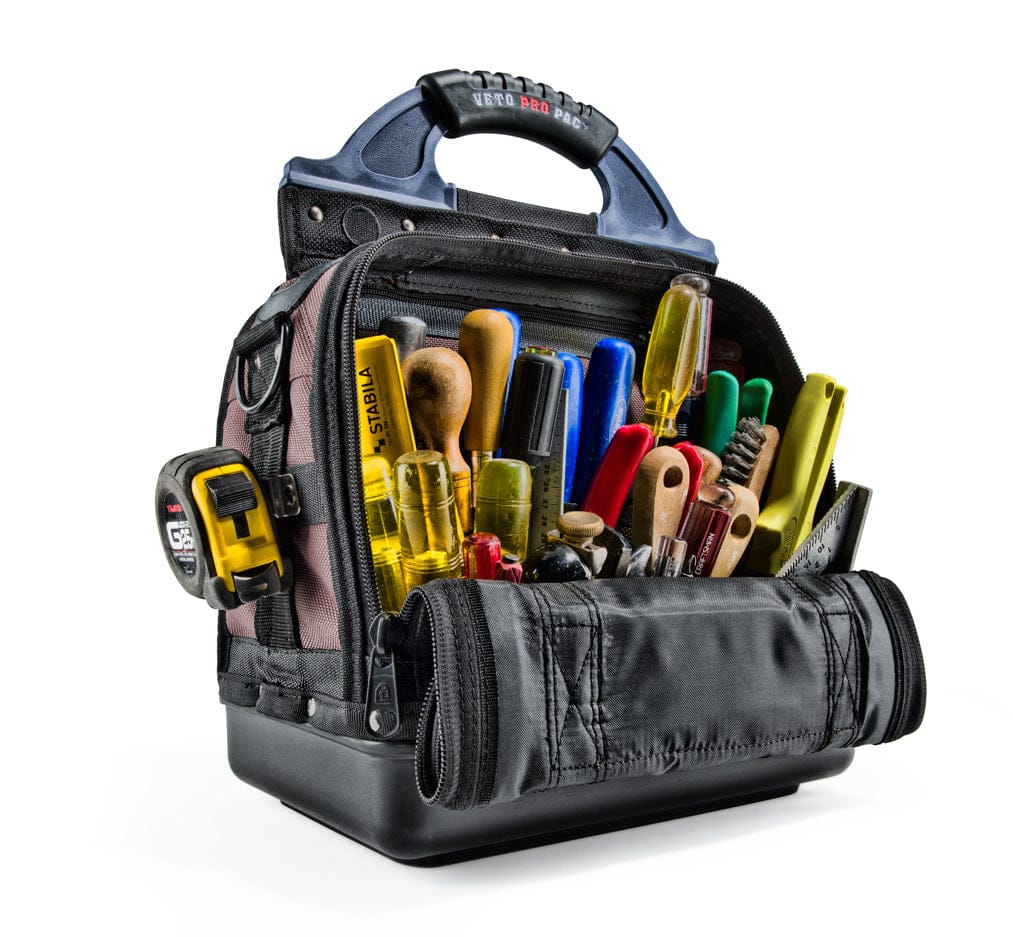 An open Veto Pro Pac Small Compact Tool Bag by VET displaying various tools, including screwdrivers, pliers, a tape measure, and a flashlight—perfect for any tradesman needing efficient tool storage.