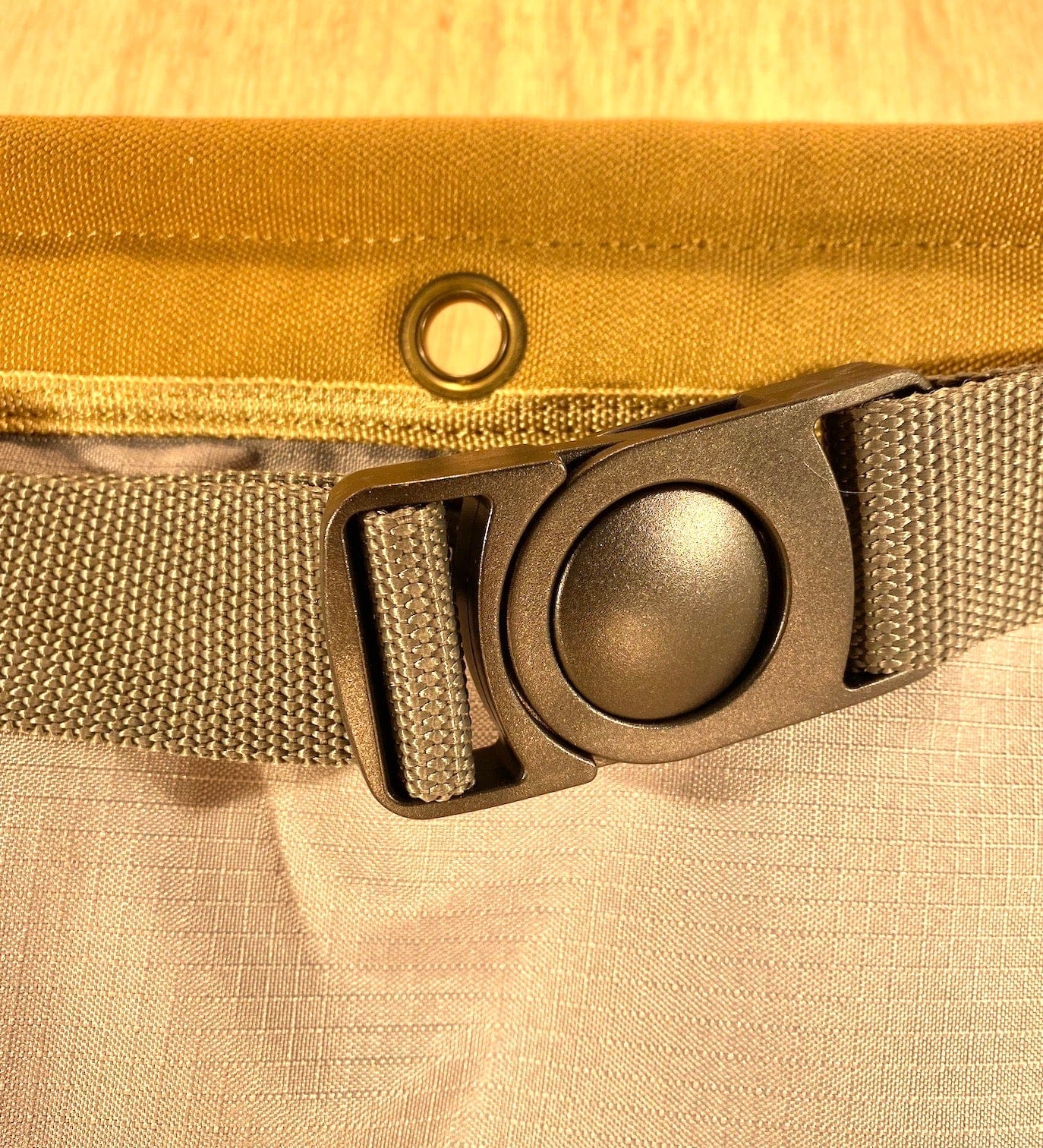 The Veto Pro Pac TA-WB Waist Apron by VET features a beige adjustable plastic-buckle strap on light fabric, with a brown canvas and metal eyelet showcasing stylish tool storage.