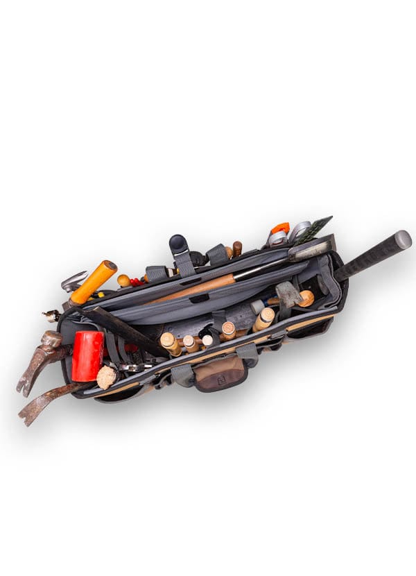 Top view of the Veto Pro Pac Timber Framer Tool Bag by VET filled with tools such as hammers, screwdrivers, and a saw, set against a white background.
