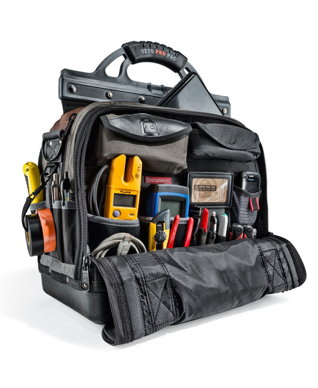 The Veto Pro Pac XLT Laptop Tool Bag by VET is open, revealing various tools and equipment inside, including pliers, a yellow multimeter, red-handled screwdrivers, and a tape measure. This versatile tech bag offers multiple compartments for effective tool storage solutions.